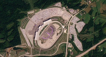 The inactive Kentucky Speedway has been transformed into a storage facility for an enormous number of unfinished Ford vehicles that may be seen from space